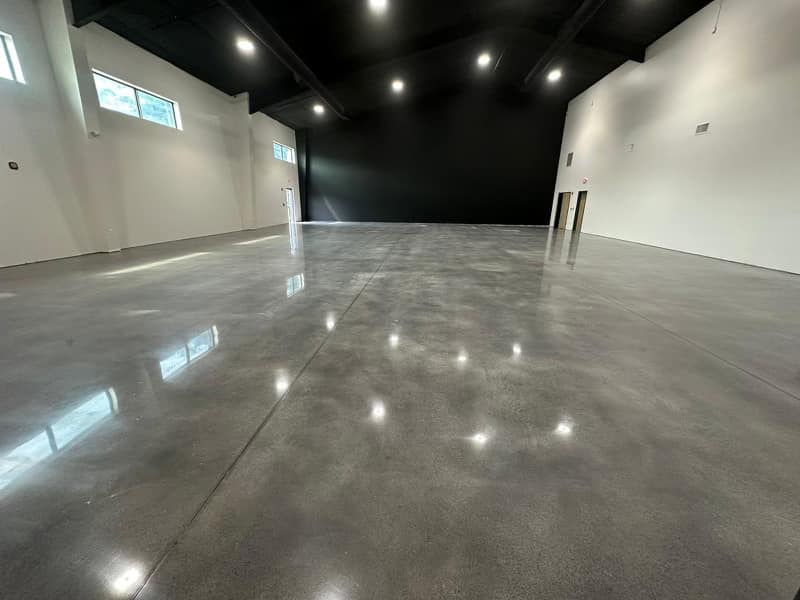 Finished cream-polished concrete floor with a clean reflective surface